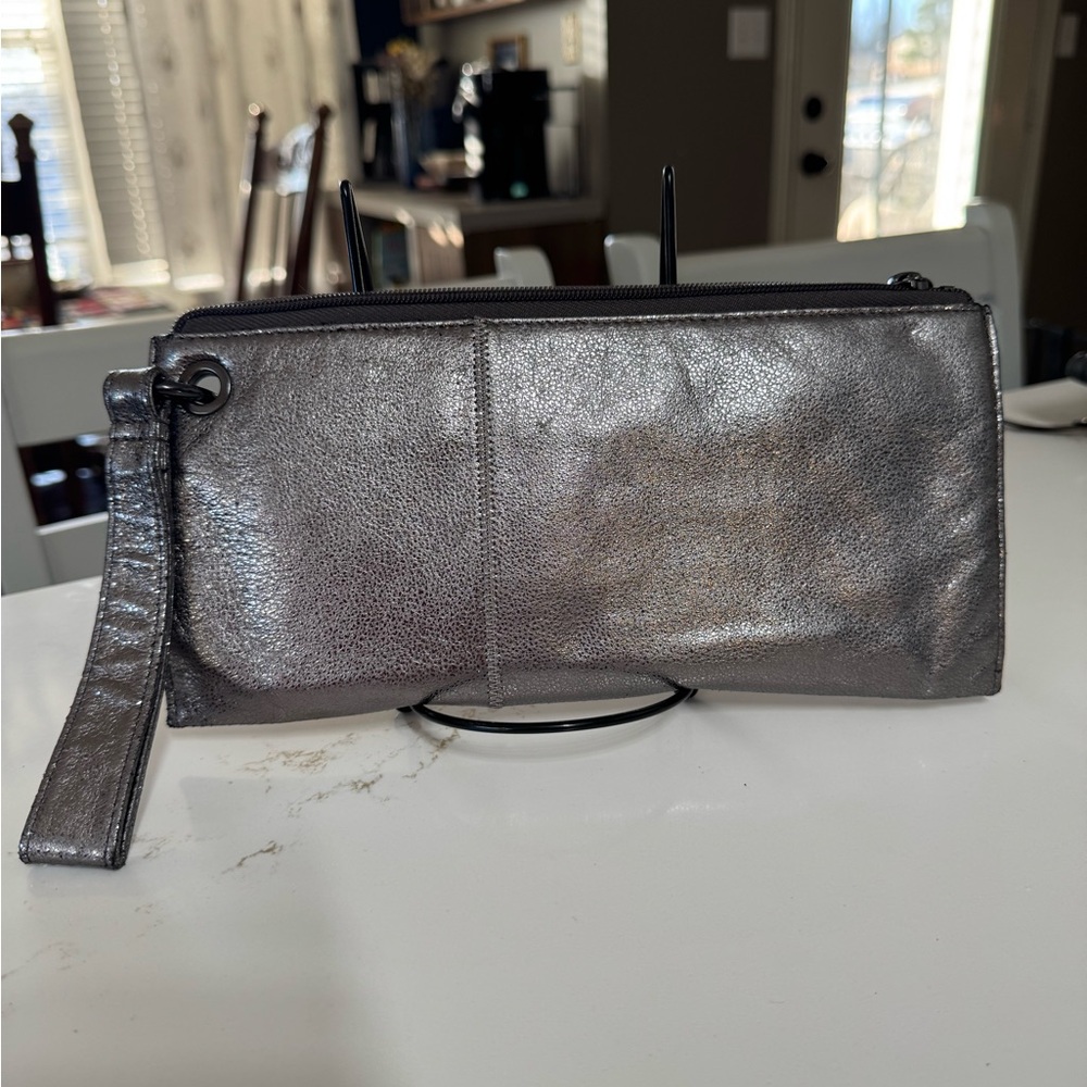 This is a Hobo International Sable metallic leather wristlet in silver